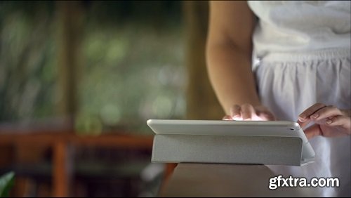 Close up shot of a woman typing on touch pad being on handrail