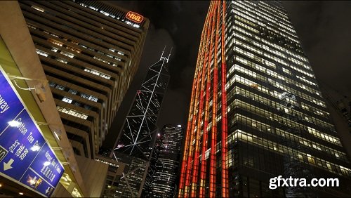 Low angle view of clouds moving over tall office buildings including the