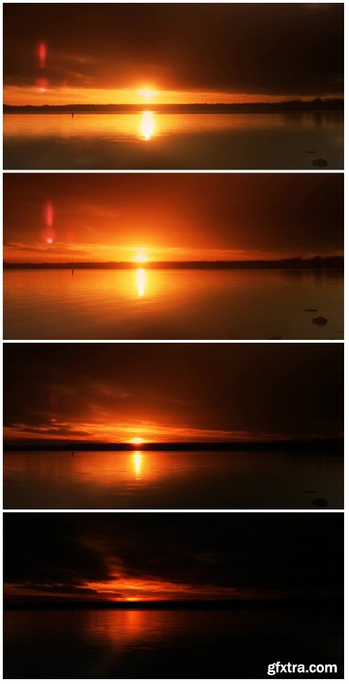 Video footage Glowing red sunrise over lake, with low clouds