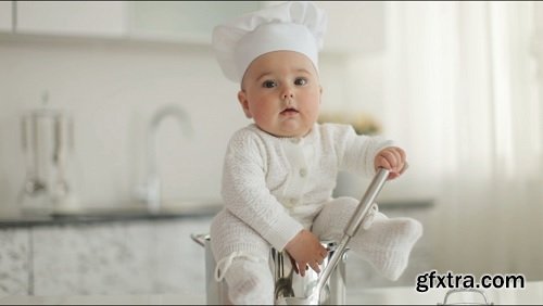 Kid sitting in a pot with a ladle