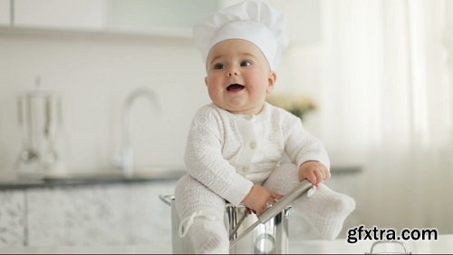 Little cook sitting in pot with ladle in hand