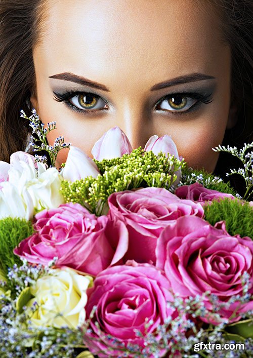 Beautiful happy girl with flowers in hands