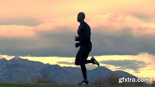 Man running in slow motion with mountain backdrop 2