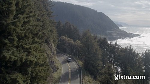 Aerial shot of cars traveling along a mountain side road