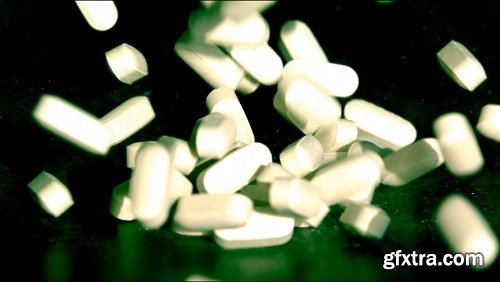 Slow motion white pills falling 2