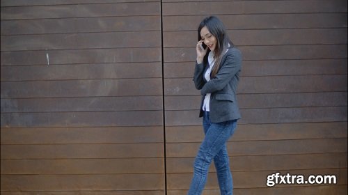 Stylish trendy woman chatting on a mobile