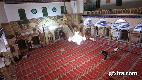 Interior shot of man in prayer at mosque