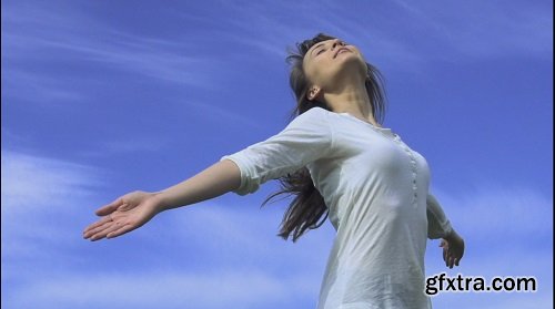 Attractive young woman dancing outdoors on a blue sky background slow motion shot at 240 fps