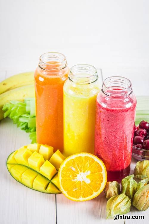 Multicolored Smoothies in Bottles of Mango, Orange, Banana, Celery, Berries