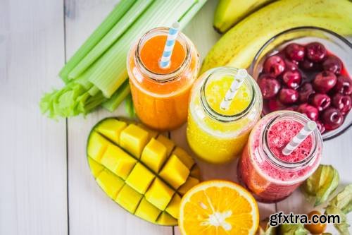 Multicolored Smoothies in Bottles of Mango, Orange, Banana, Celery, Berries