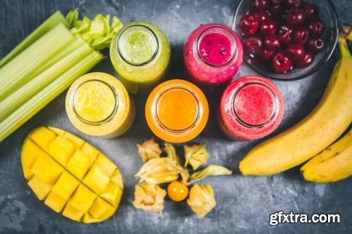 Multicolored Smoothies in Bottles of Mango, Orange, Banana, Celery, Berries