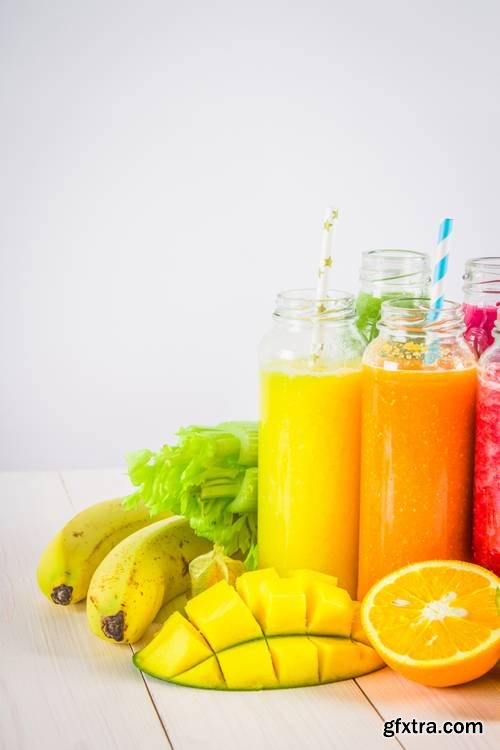 Multicolored Smoothies in Bottles of Mango, Orange, Banana, Celery, Berries