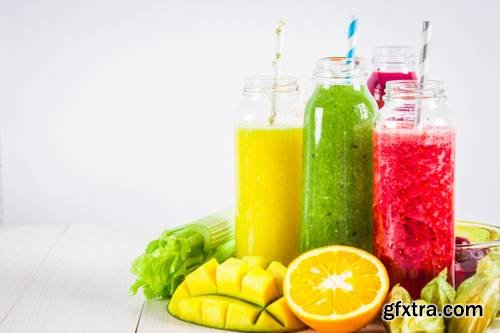 Multicolored Smoothies in Bottles of Mango, Orange, Banana, Celery, Berries