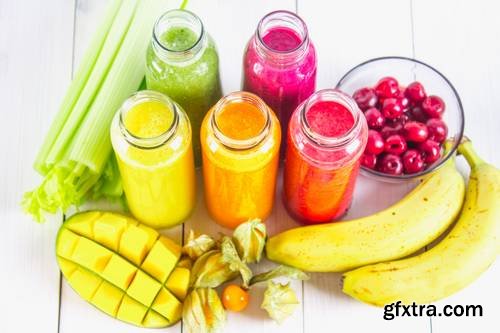 Multicolored Smoothies in Bottles of Mango, Orange, Banana, Celery, Berries