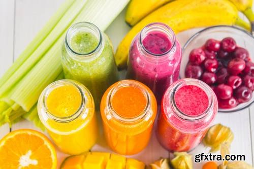 Multicolored Smoothies in Bottles of Mango, Orange, Banana, Celery, Berries