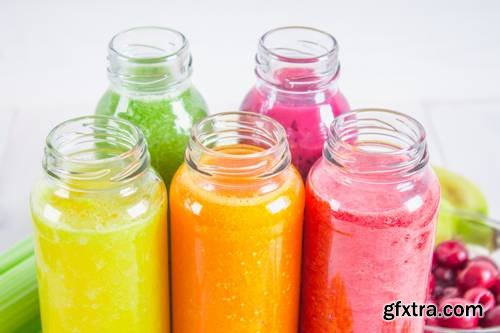 Multicolored Smoothies in Bottles of Mango, Orange, Banana, Celery, Berries