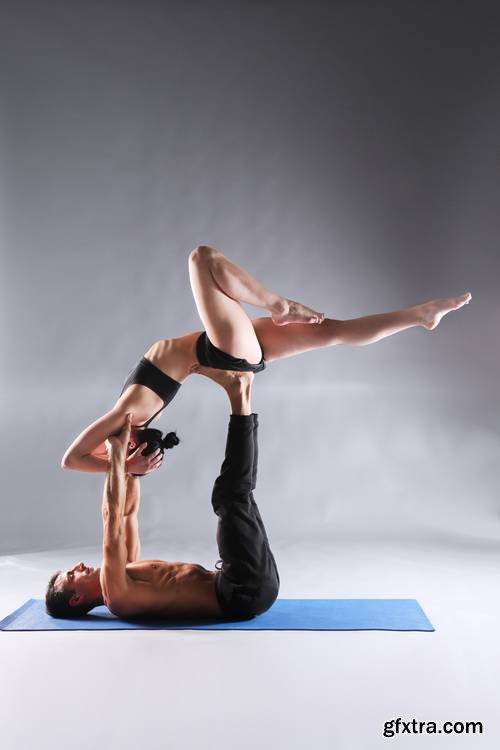 Young Couple Practicing Acro Yoga