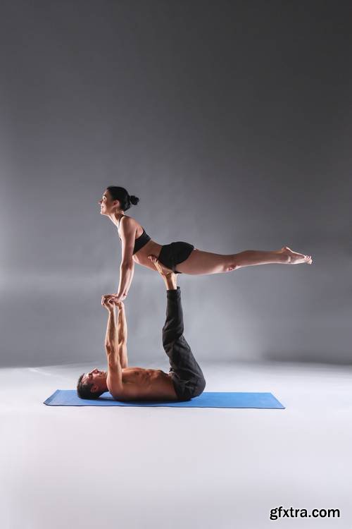 Young Couple Practicing Acro Yoga