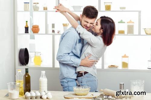 Loving Happy Couple Preparing Healthy Salad of Fresh Vegetables in Kitchen