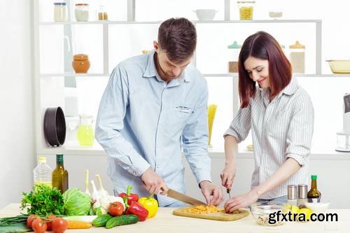 Loving Happy Couple Preparing Healthy Salad of Fresh Vegetables in Kitchen