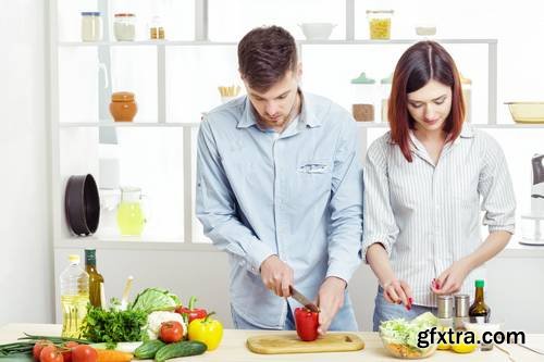 Loving Happy Couple Preparing Healthy Salad of Fresh Vegetables in Kitchen