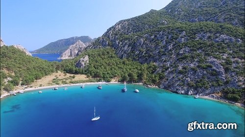 4K Aerial Clip Of Cove, Sea, Boats And Mountain