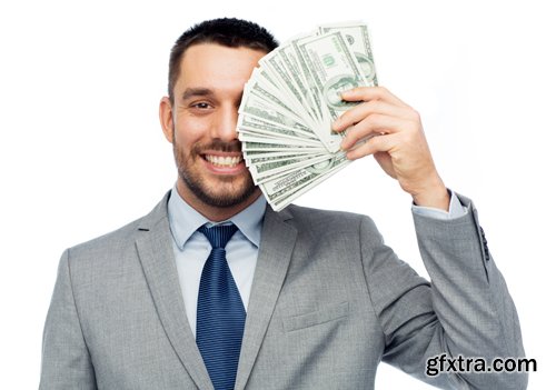 Happy businessman with heap of money in office