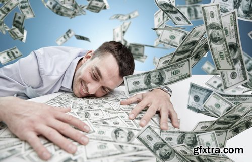 Happy businessman with heap of money in office