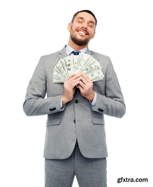 Happy businessman with heap of money in office