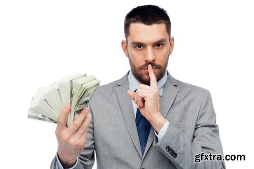 Happy businessman with heap of money in office