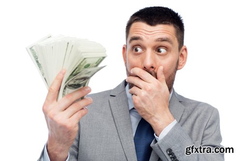 Happy businessman with heap of money in office