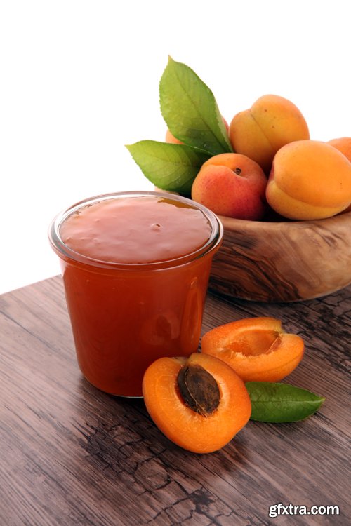 Apricot jam in glass bowl with fruit around