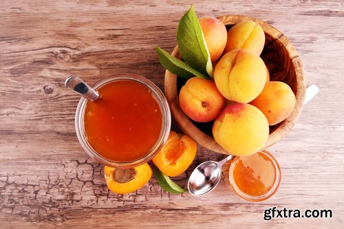 Apricot jam in glass bowl with fruit around