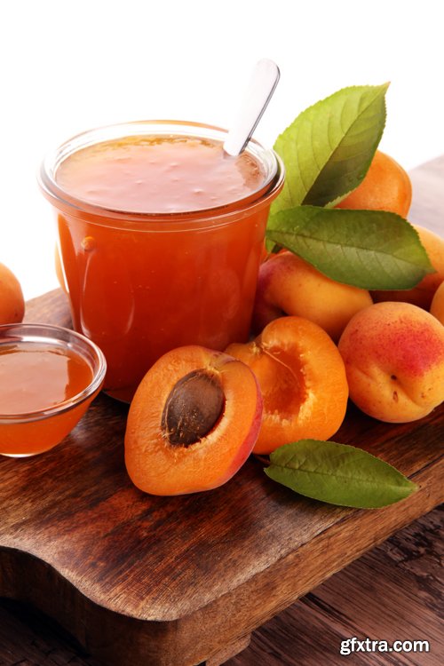 Apricot jam in glass bowl with fruit around