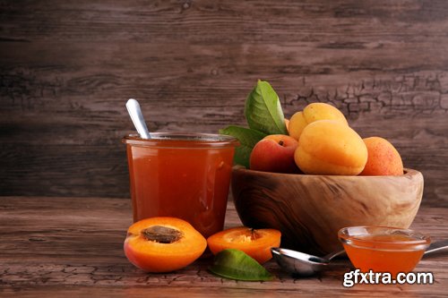 Apricot jam in glass bowl with fruit around