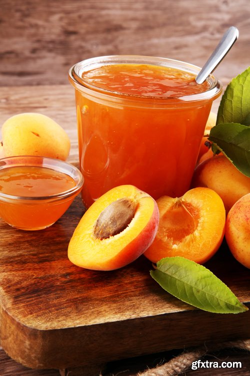 Apricot jam in glass bowl with fruit around