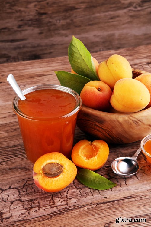 Apricot jam in glass bowl with fruit around