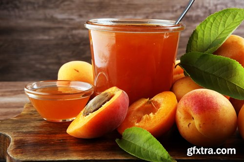 Apricot jam in glass bowl with fruit around