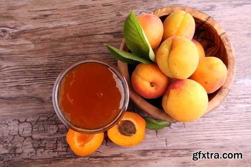 Apricot jam in glass bowl with fruit around