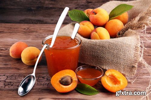 Apricot jam in glass bowl with fruit around