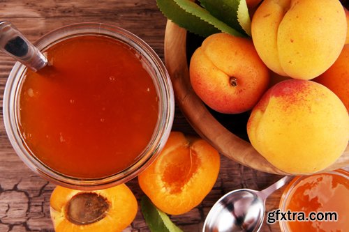 Apricot jam in glass bowl with fruit around