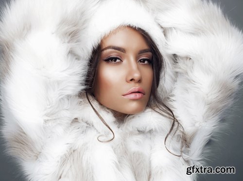 Beautiful woman in white fur coat and fur hat