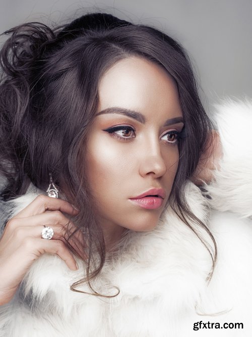 Beautiful woman in white fur coat and fur hat