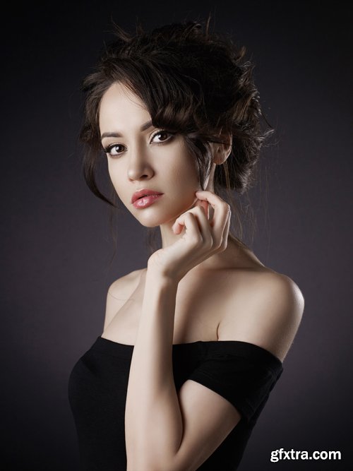 Beautiful woman with elegant hairstyle on black background