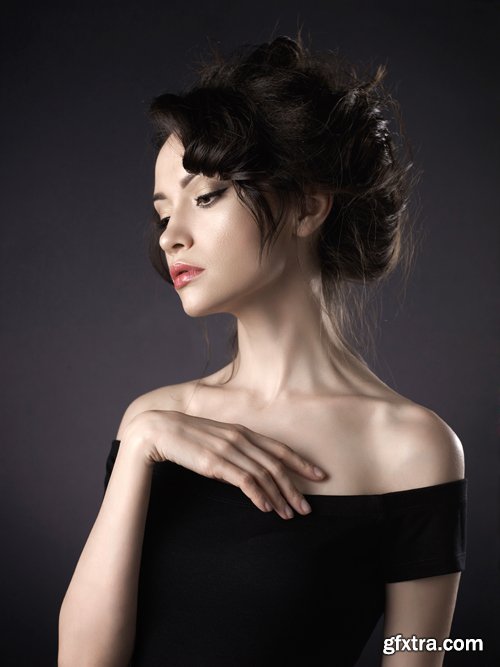 Beautiful woman with elegant hairstyle on black background