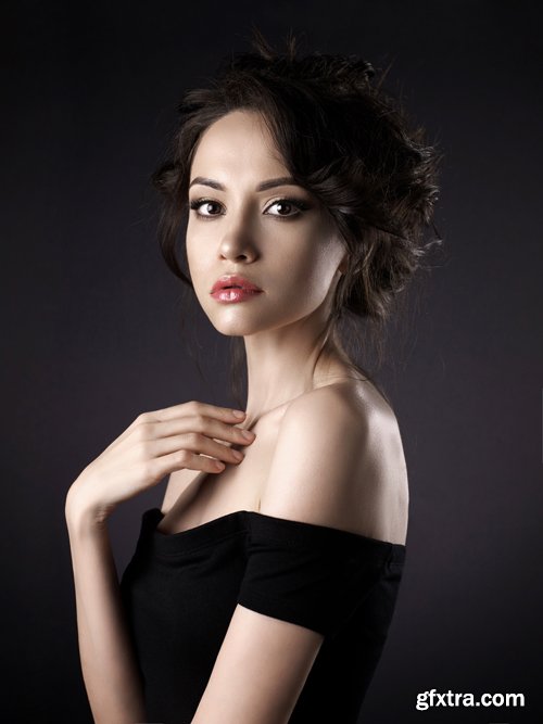 Beautiful woman with elegant hairstyle on black background