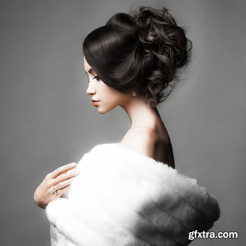 Fashion studio portrait of beautiful lady with elegant hairstyle in white fur coat