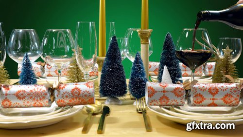Festive Christmas lunch table in modern gold, copper, and white theme against a green background