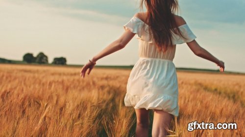 Beautiful Girl Running On Sunlit Wheat Field