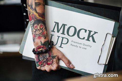 Tattooed hand with a clipboard paper mockup